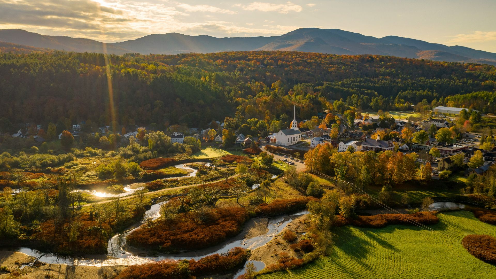 an aerial view of a small town surrounded by mountains