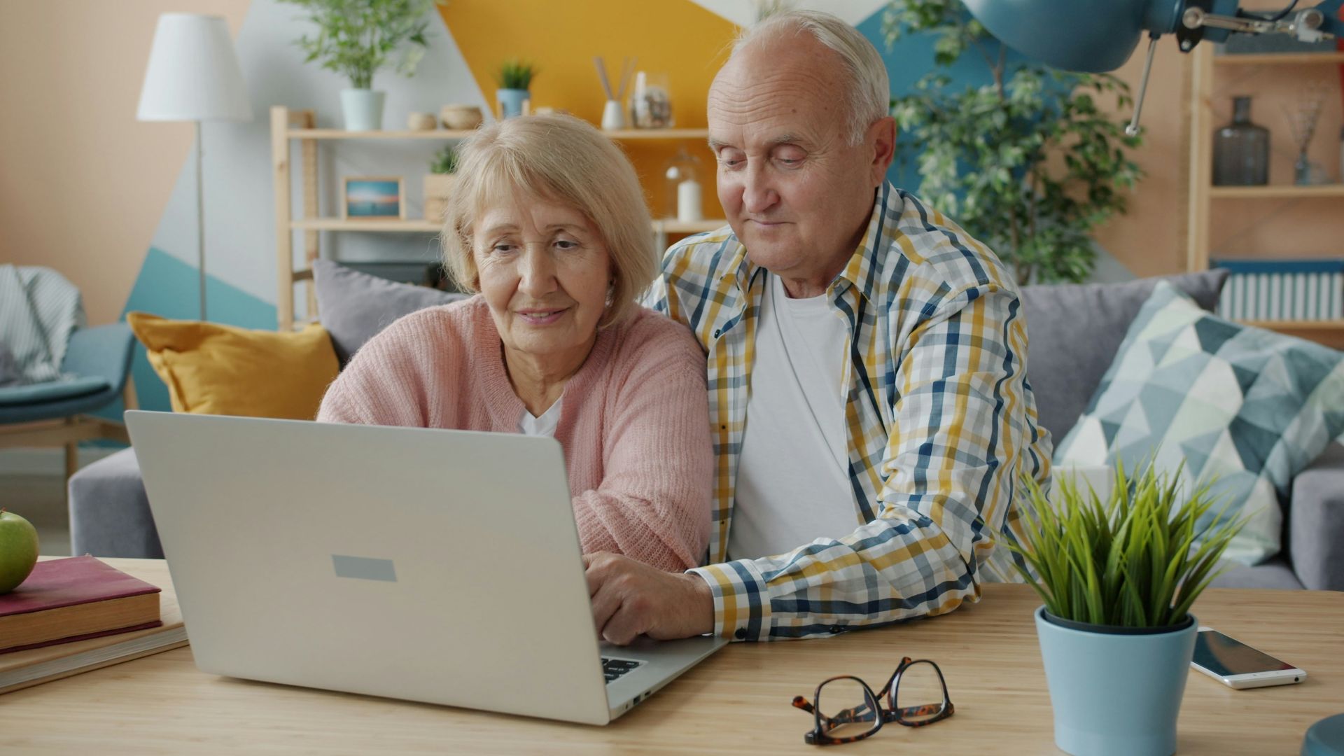 Elderly couple looking at a laptop together