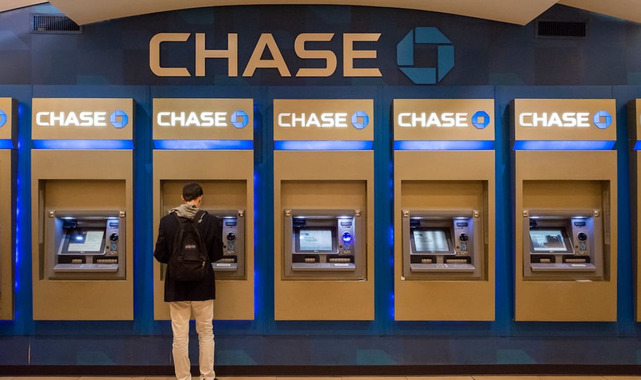 Man Standing near ATMs