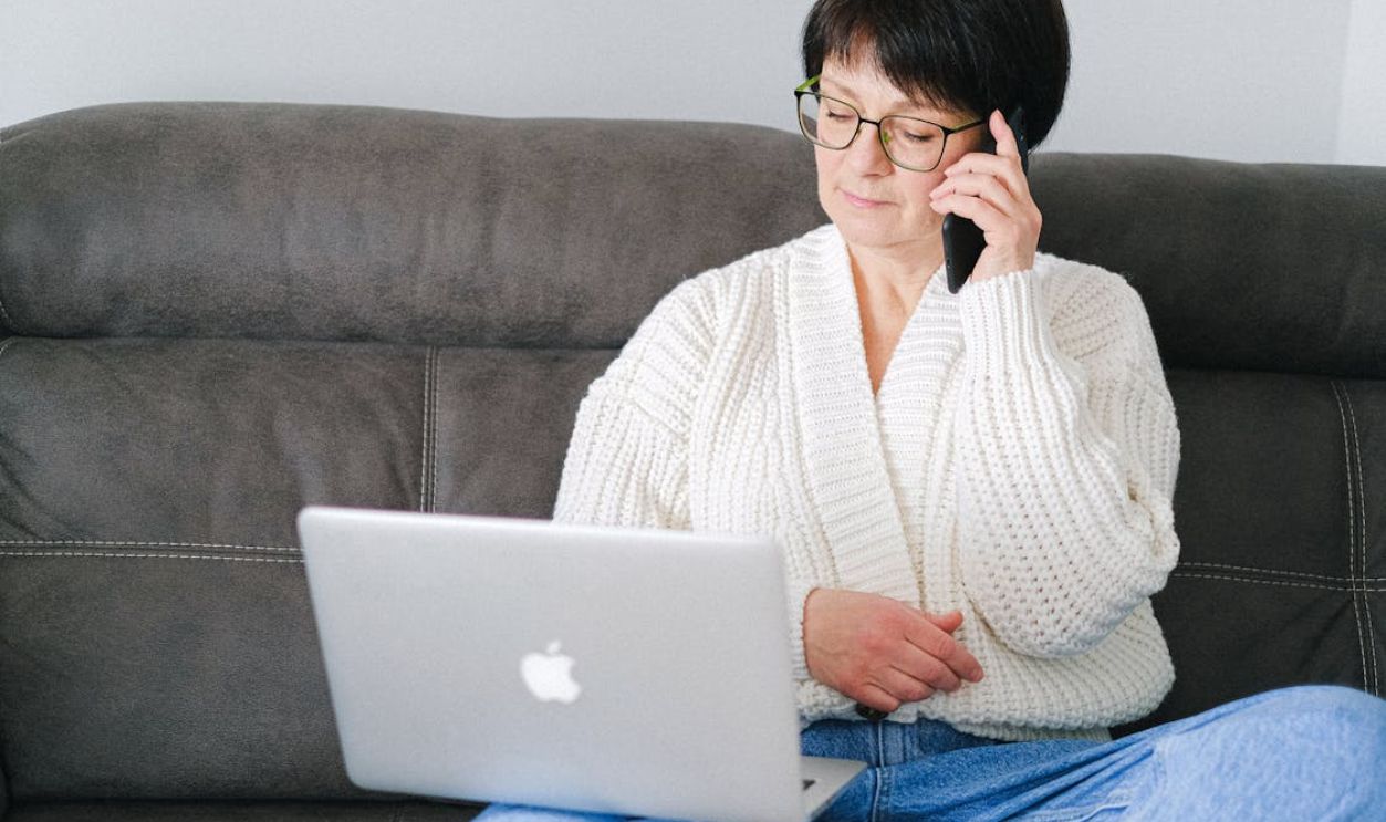 Close-Up Shot of an Elderly Woman with Eyeglasses Having a Phone Call