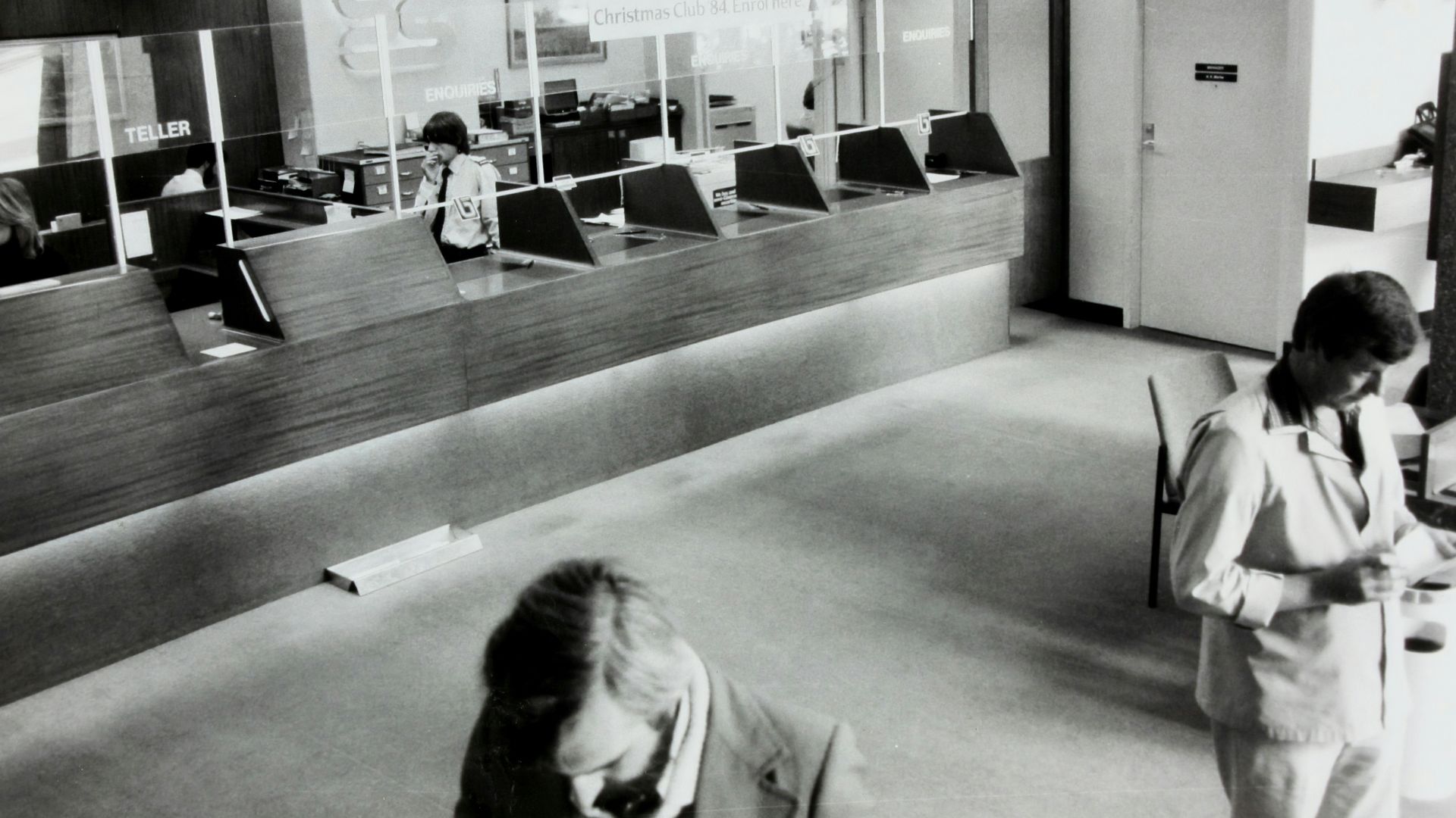 grayscale photo of man holding paper