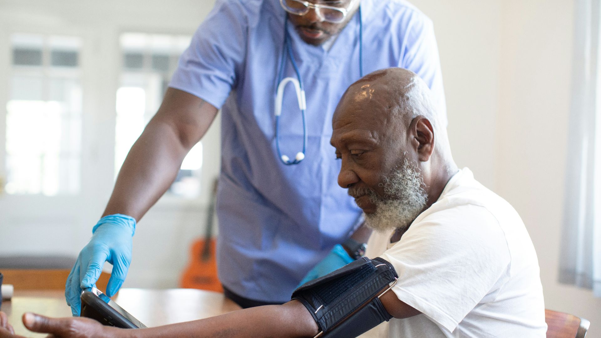 a doctor checking a patient's blood pressure