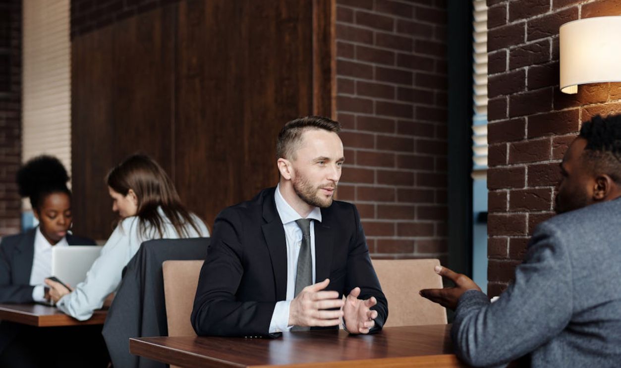 Businessmen Talking at a Cafe