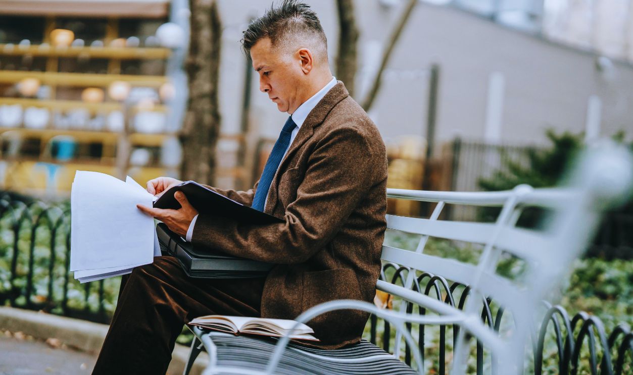 Photo Of Man Looking Through Papers