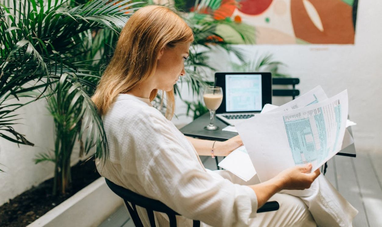 A Woman Reviewing Documents while Sitting