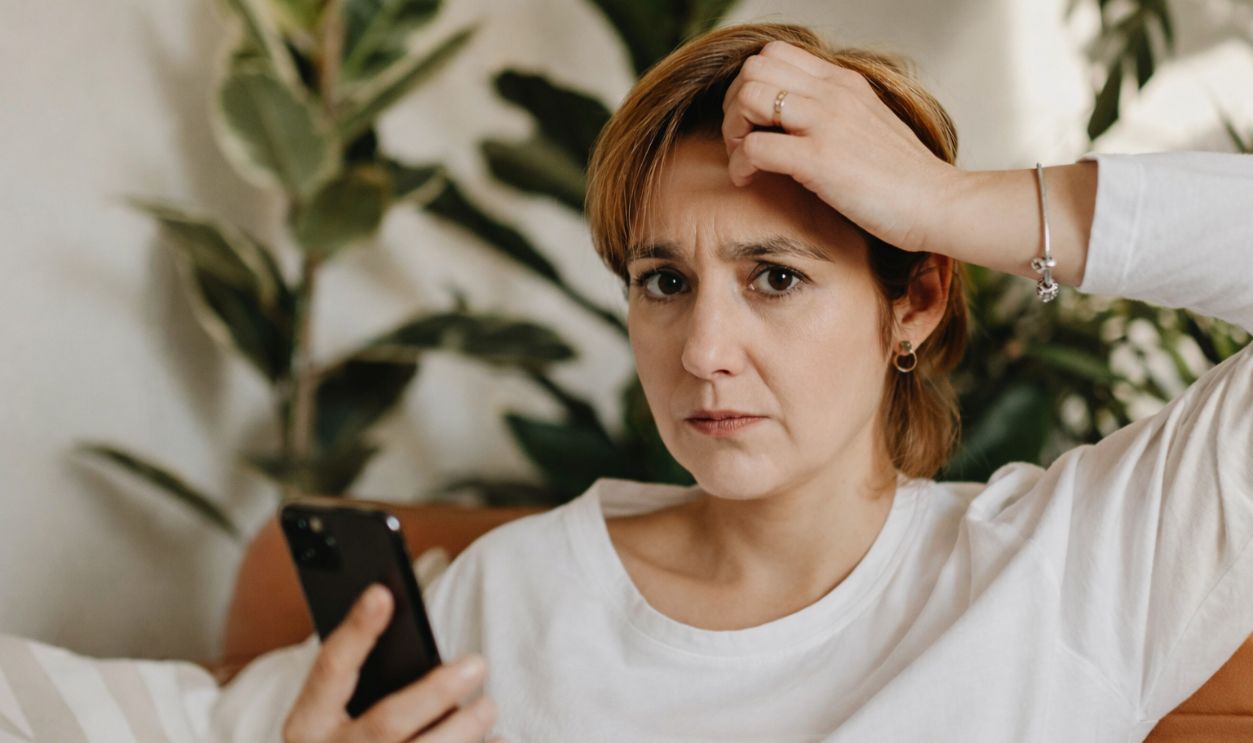 Worried woman using a phone