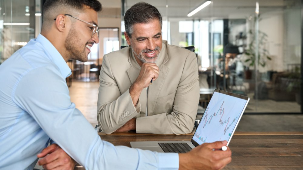 Financial advisor consulting investor explaining financial trade stock data