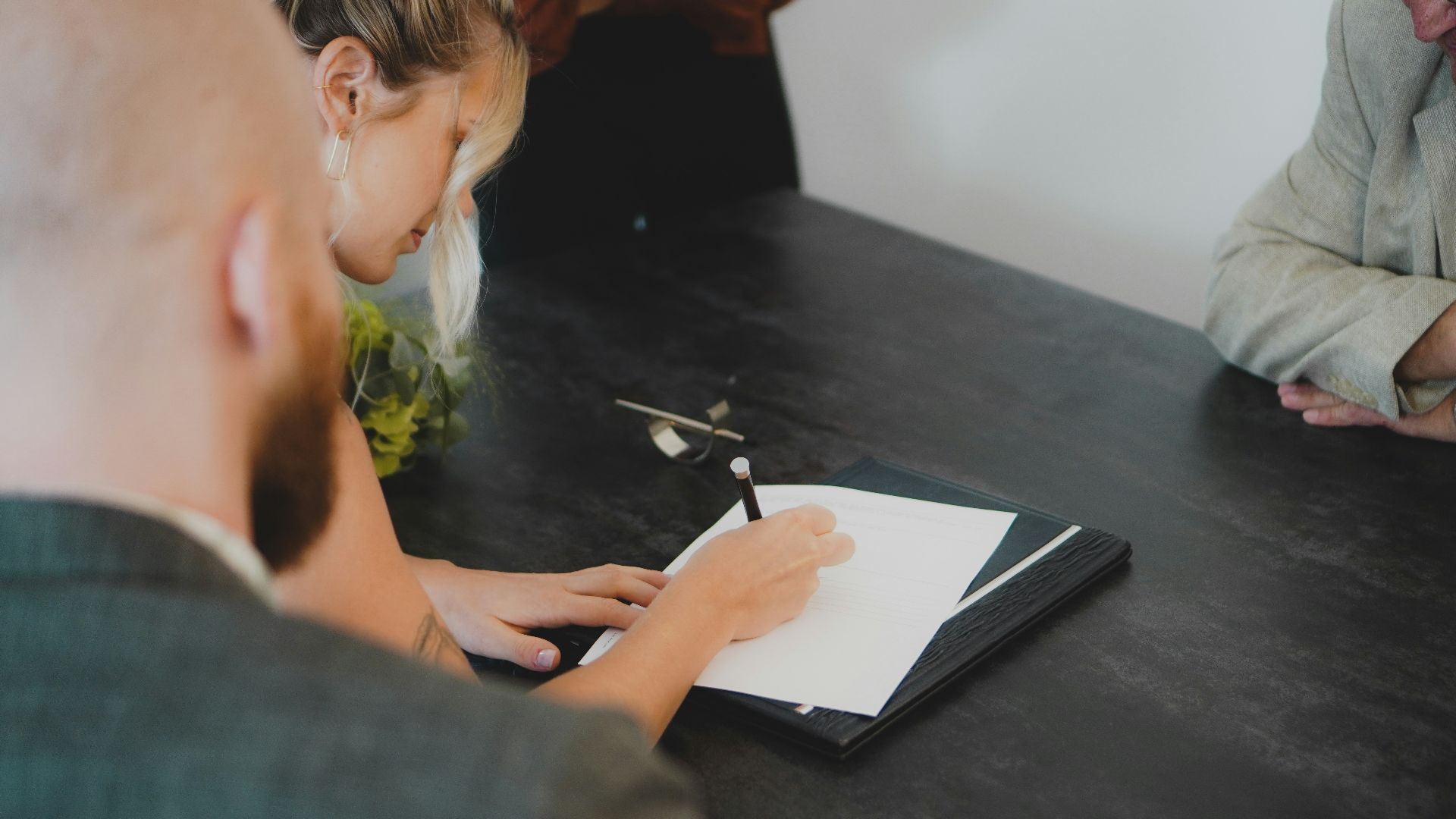 a man writing on a piece of paper