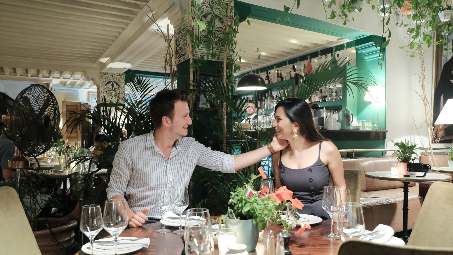 a man and woman sitting at a table in a restaurant