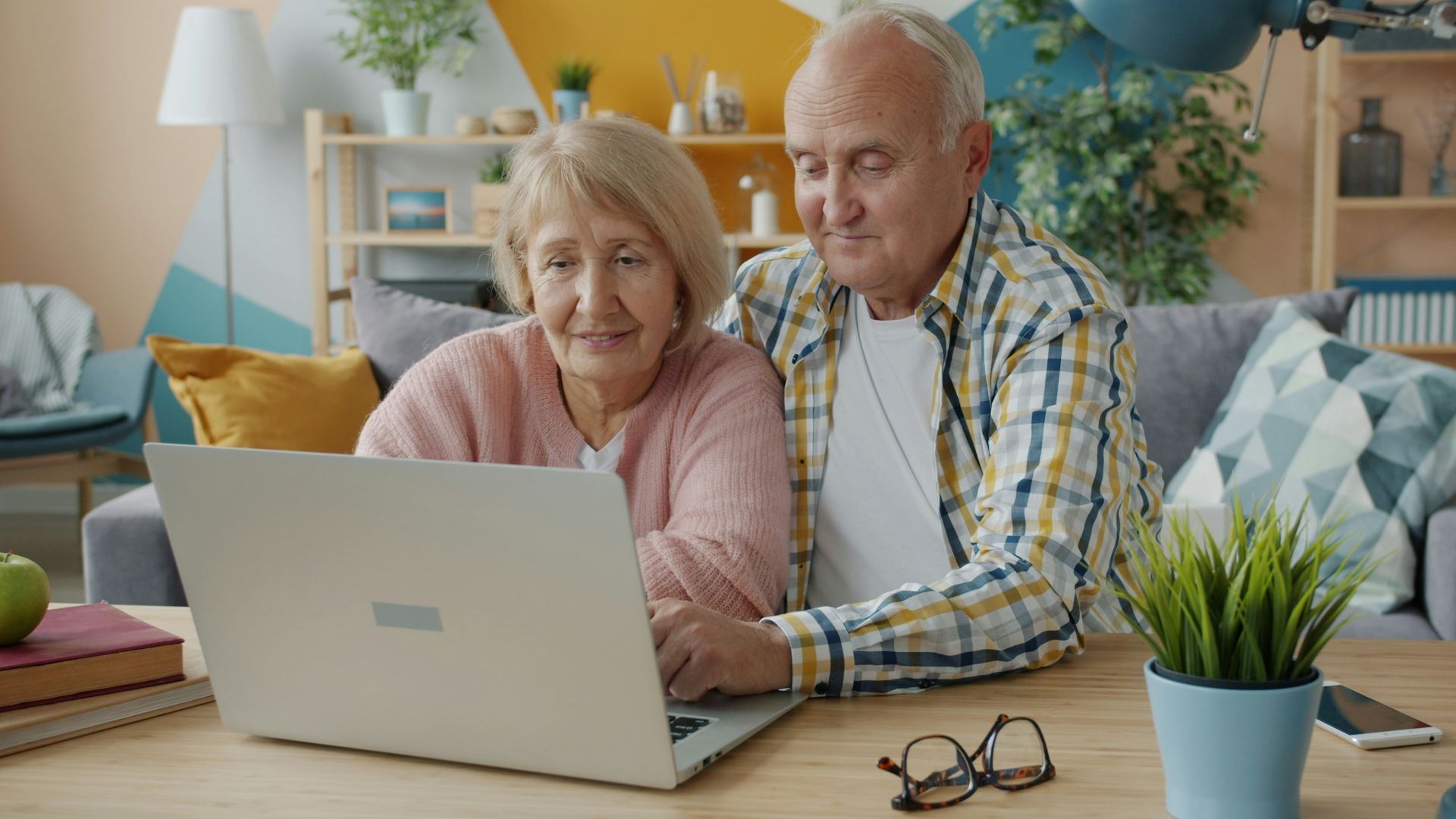 Elderly couple looking at a laptop together