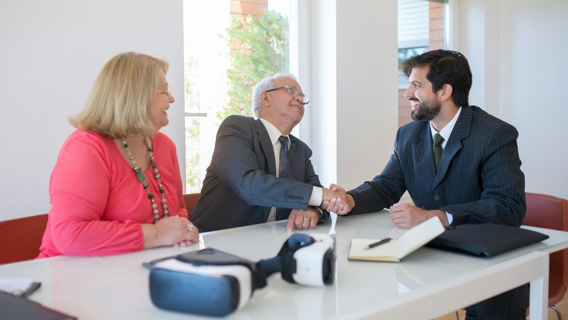 Business professionals engaged in a friendly handshake during a meeting.