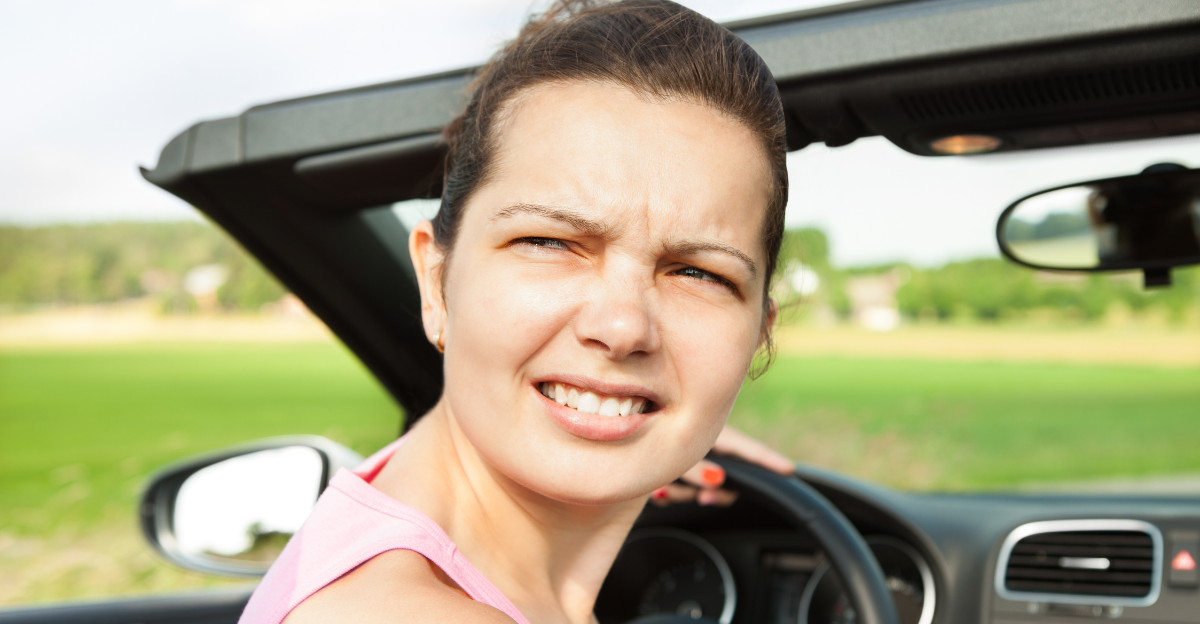 Young Woman Looking Back While Travelling In Car