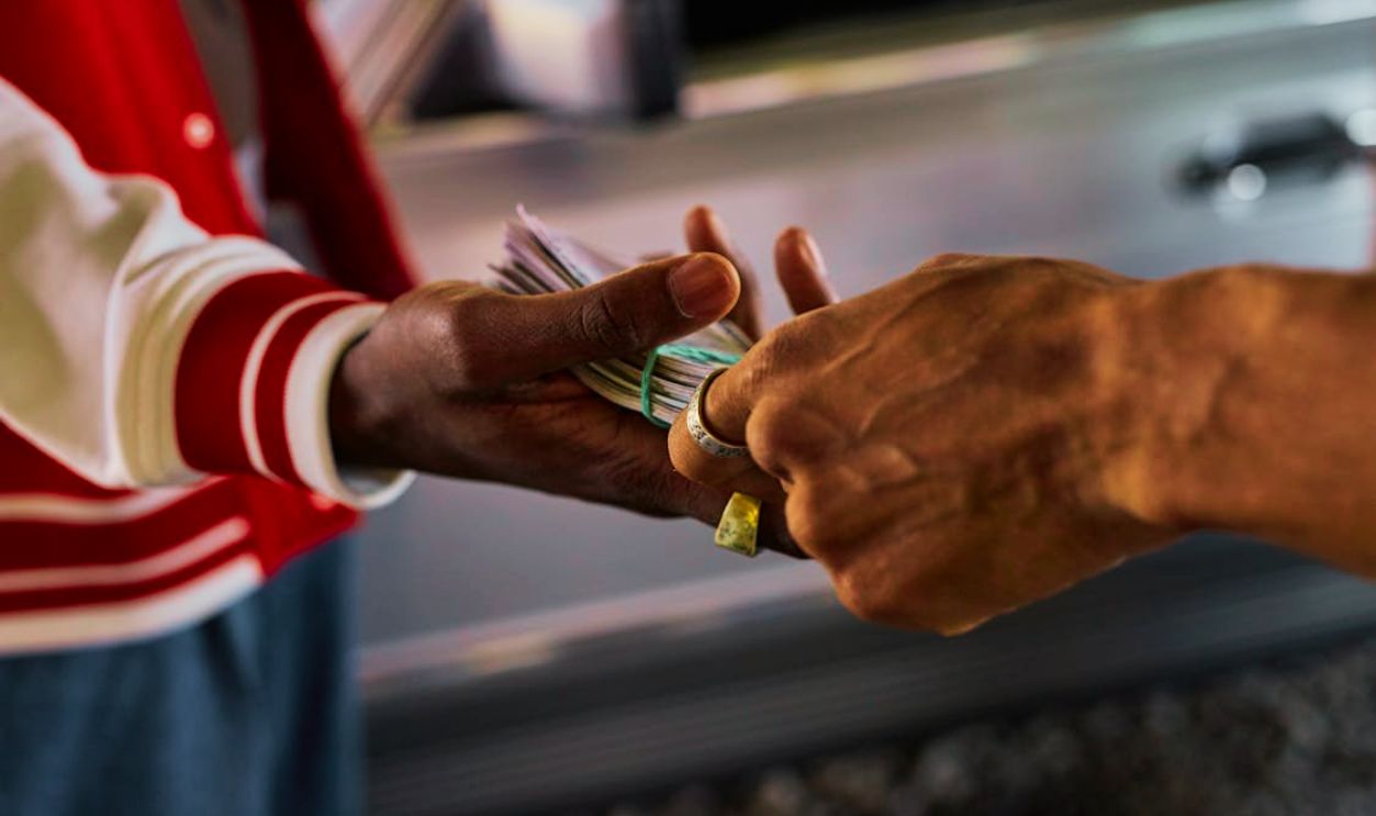 A Person Handing Money to a Person