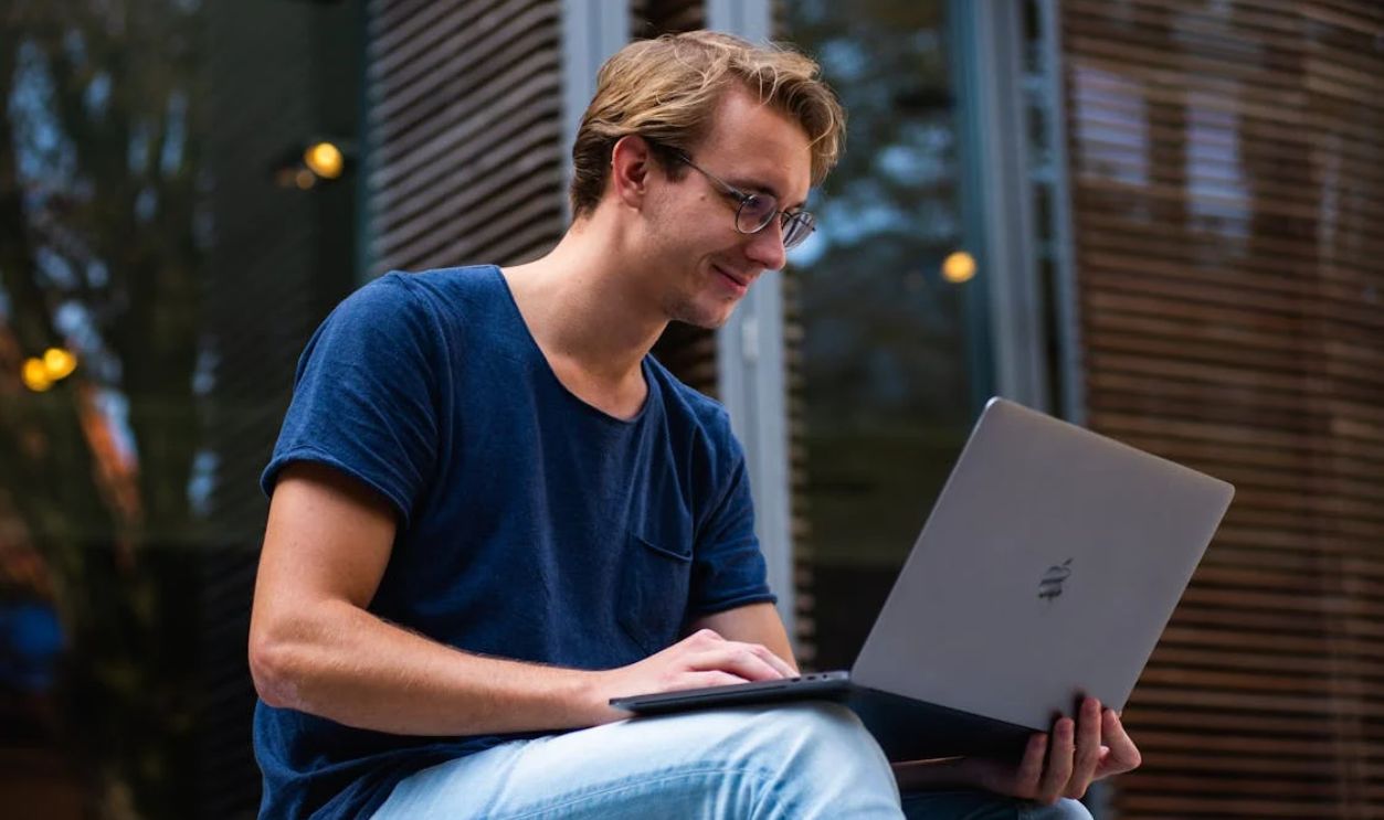 Selective Focus Photo of Man Using Laptop