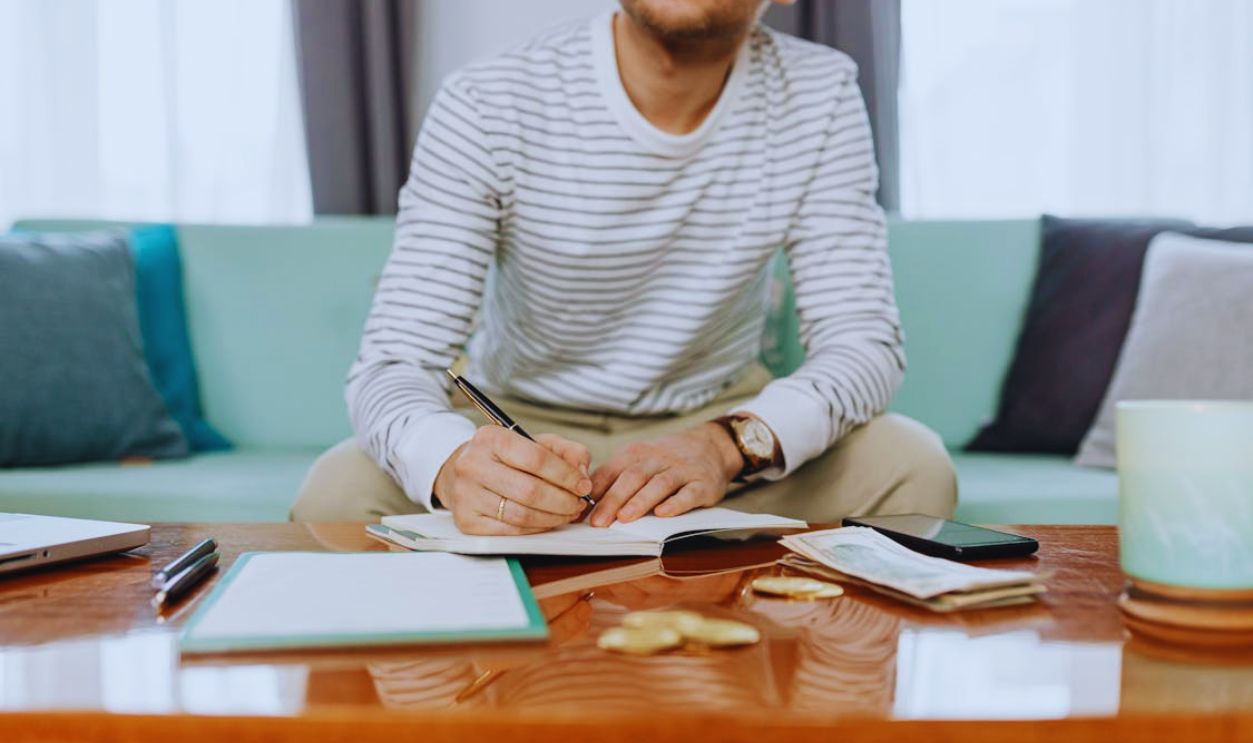 Man in White and Gray Striped Long Sleeve Shirt Sitting at the Table