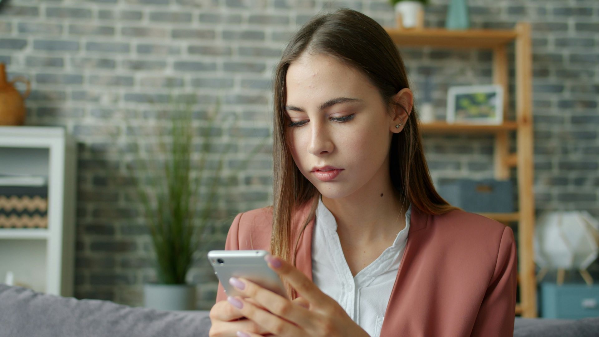 Young woman looking at her smartphone screen.