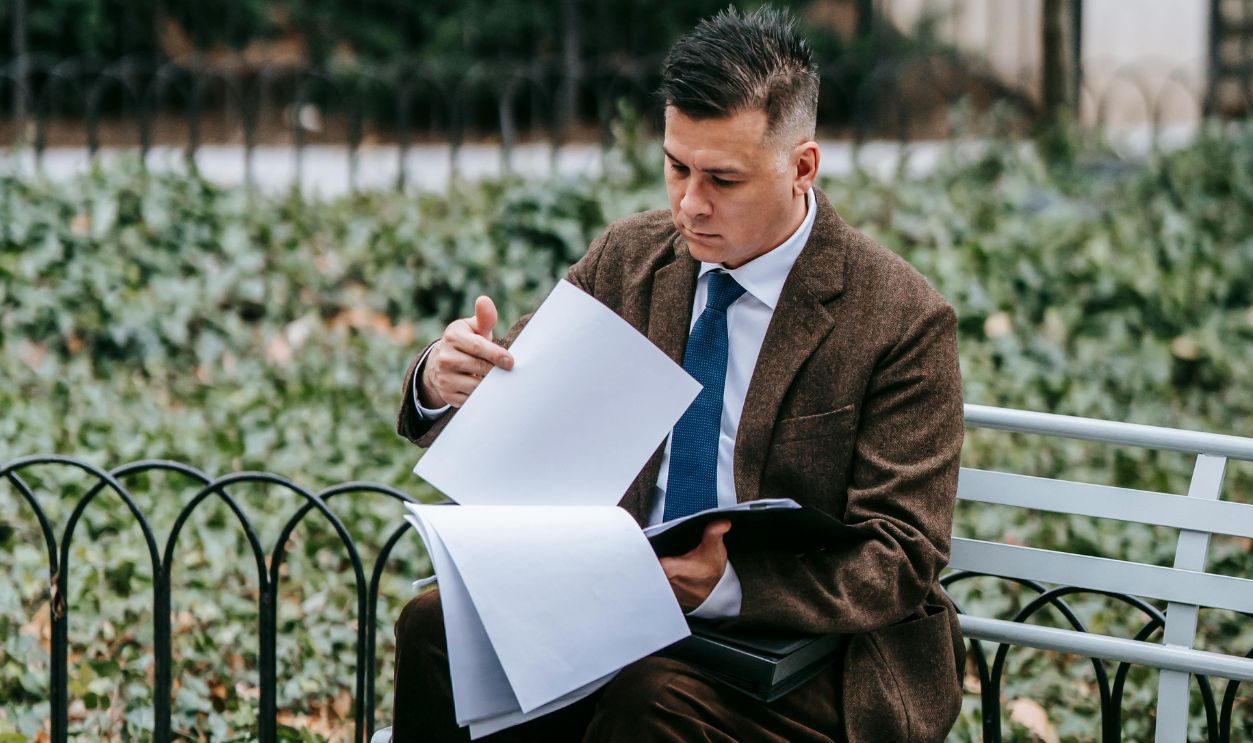 Photo Of Man Reviewing The Documents