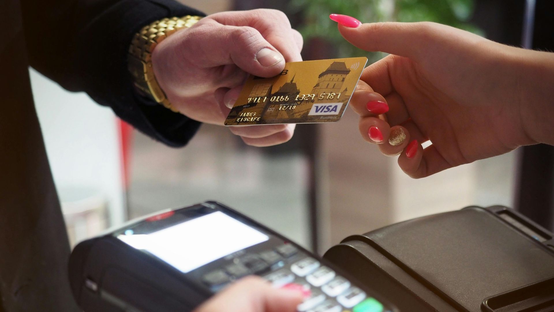 Close-up of a credit card payment being processed at a POS terminal.