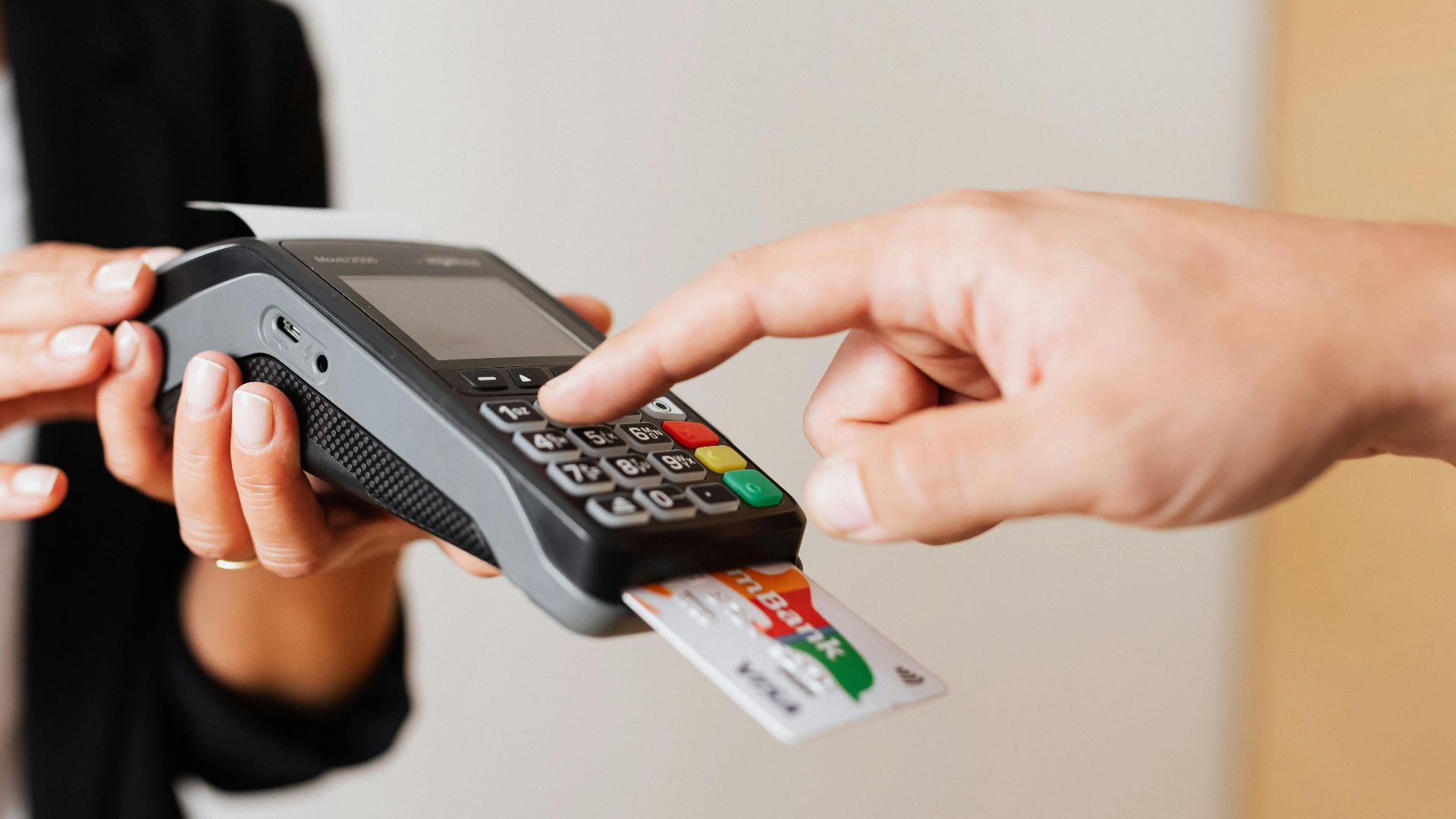 A customer using a contactless payment terminal for secure and cashless transactions indoors.