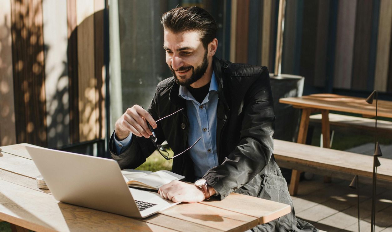 Man in Black Jacket Sitting on Wooden Bench