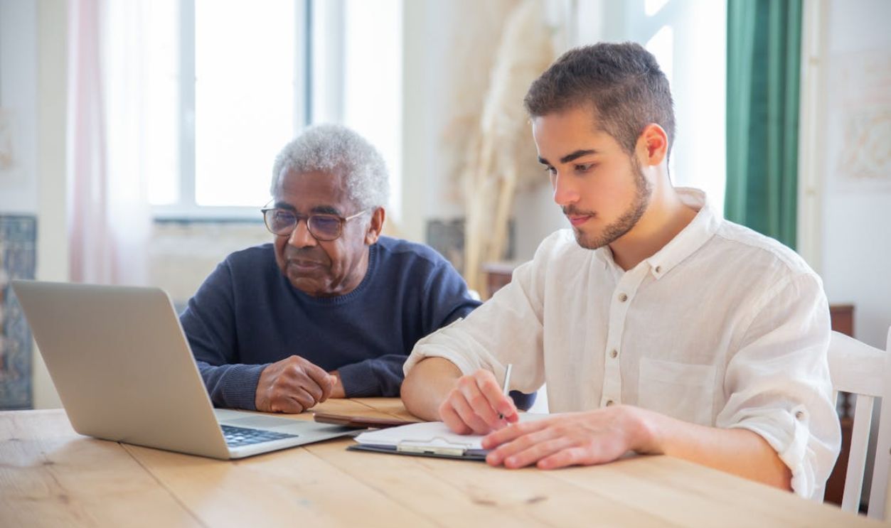 Two People Sitting with a Laptop