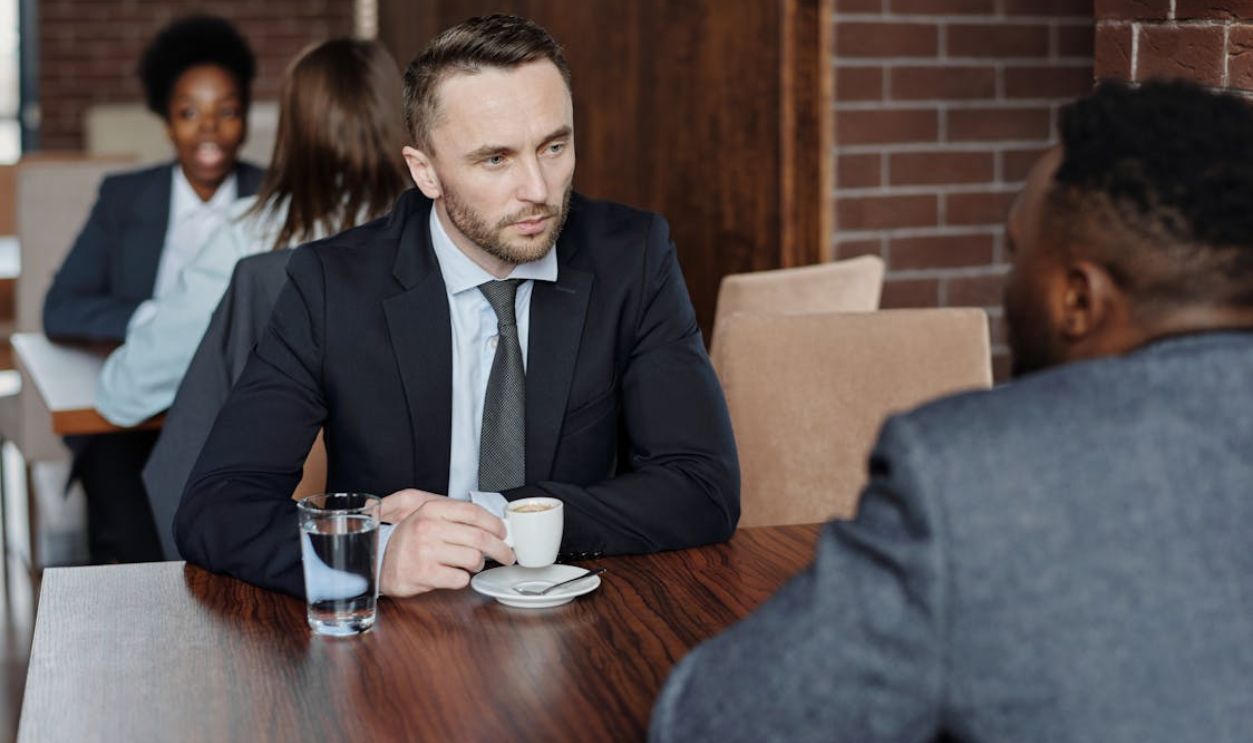 Businessmen Having a Meeting at a Cafe