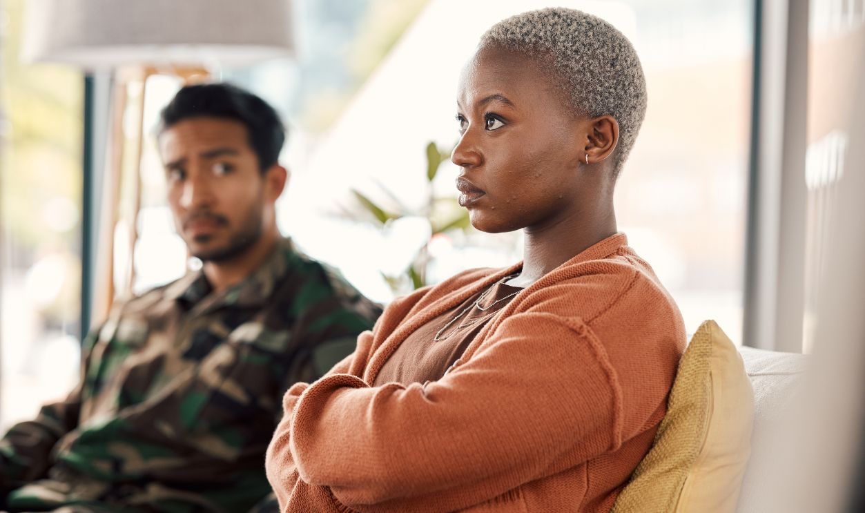 Fight, conflict and couple on sofa in therapy for argument, marriage problem and divorce counseling. Psychology, mental health and upset woman with military or veteran man for ptsd, help and support