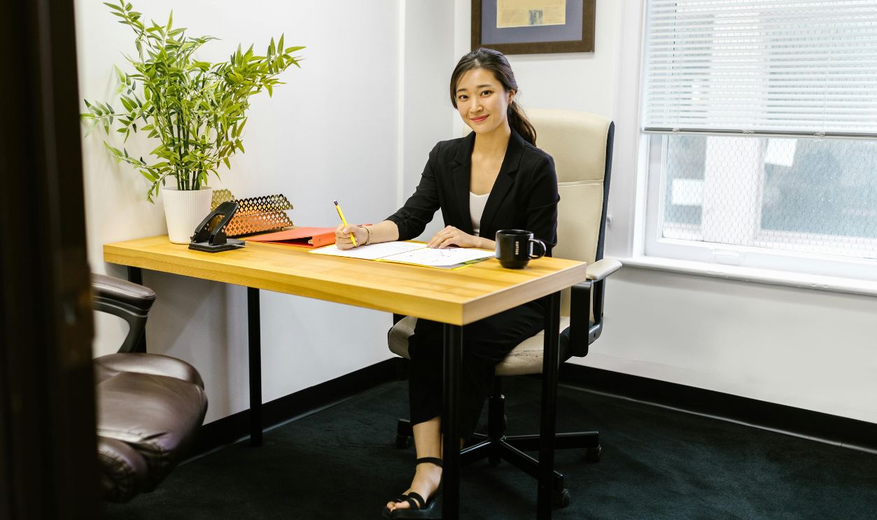 Woman in Black Long Sleeve Shirt Sitting on the Office Chair