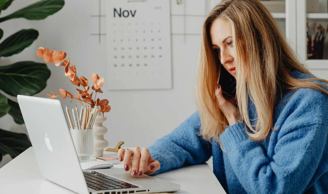Woman in Blue Denim Jacket Sitting by the Table
