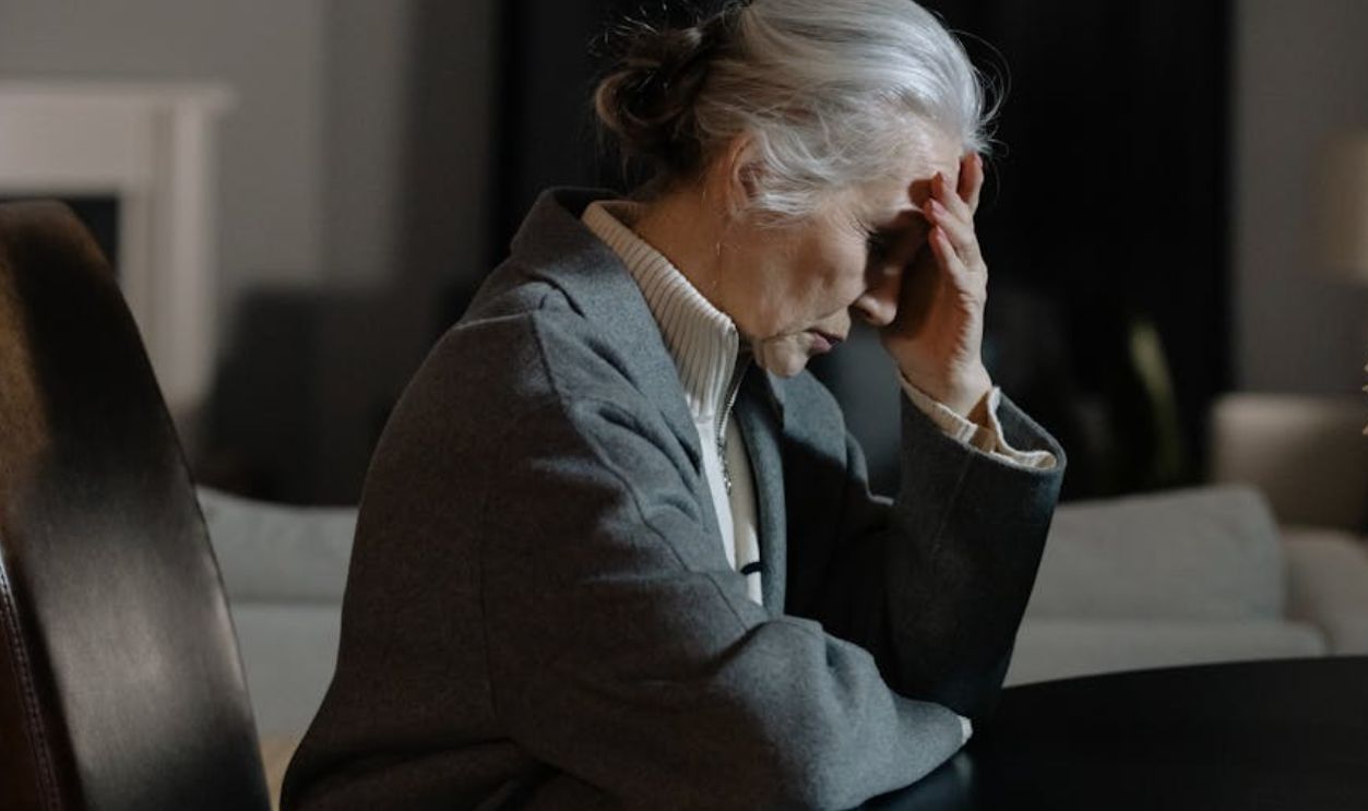 Woman in Gray Blazer Sitting on Black Chair