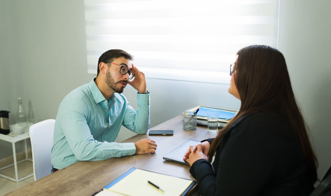 Client meeting with a lawyer, discussing a legal problem and receiving professional consultation in a modern office