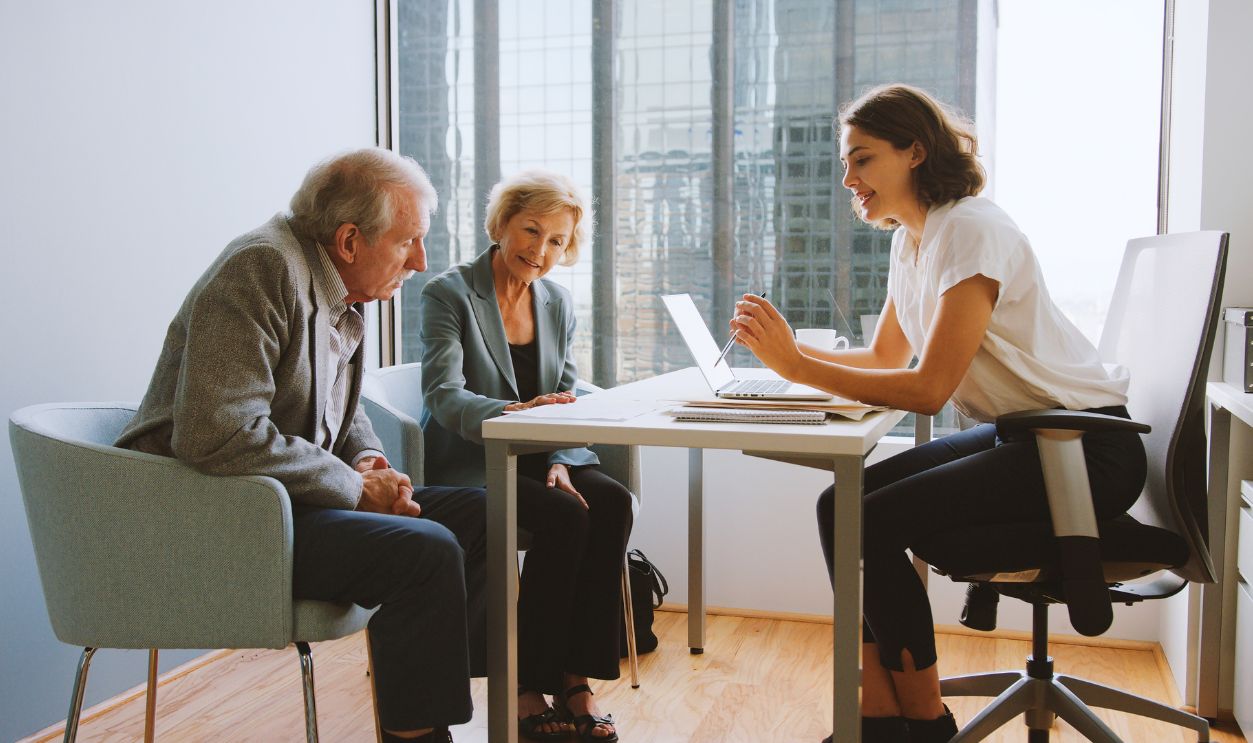 2700934625, Senior Couple Meeting With Female Financial Advisor In Office