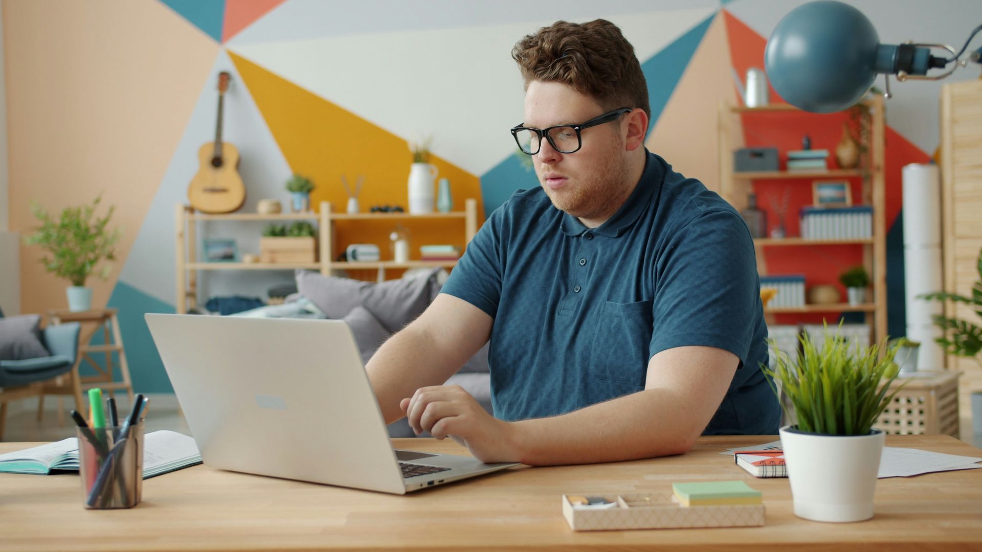 Man working on a laptop at a desk.