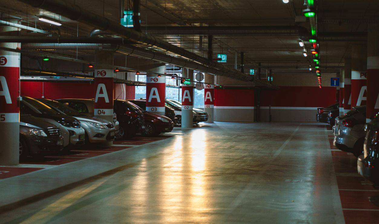 Cars Parked on Red Level of Parking