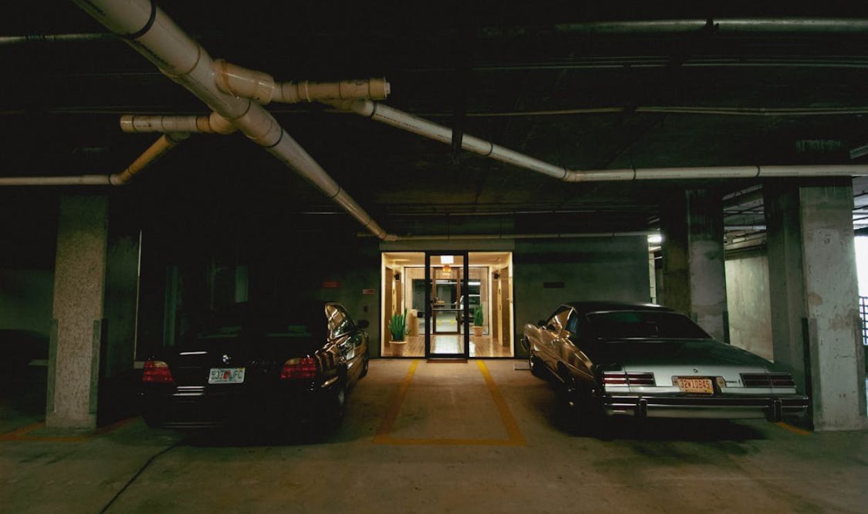 Dimly Lit Underground Parking Garage with Cars