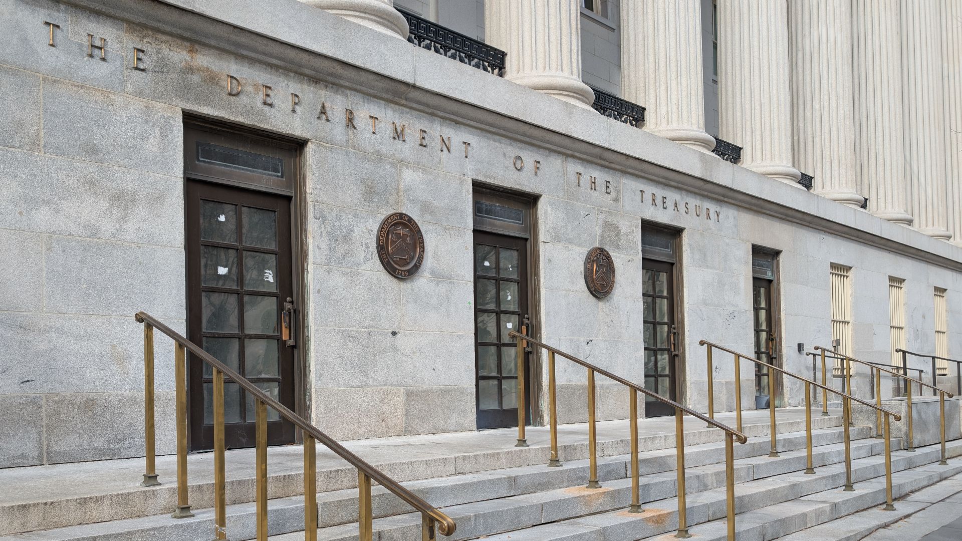 The side entrance to the treasury building with a sign above it that says