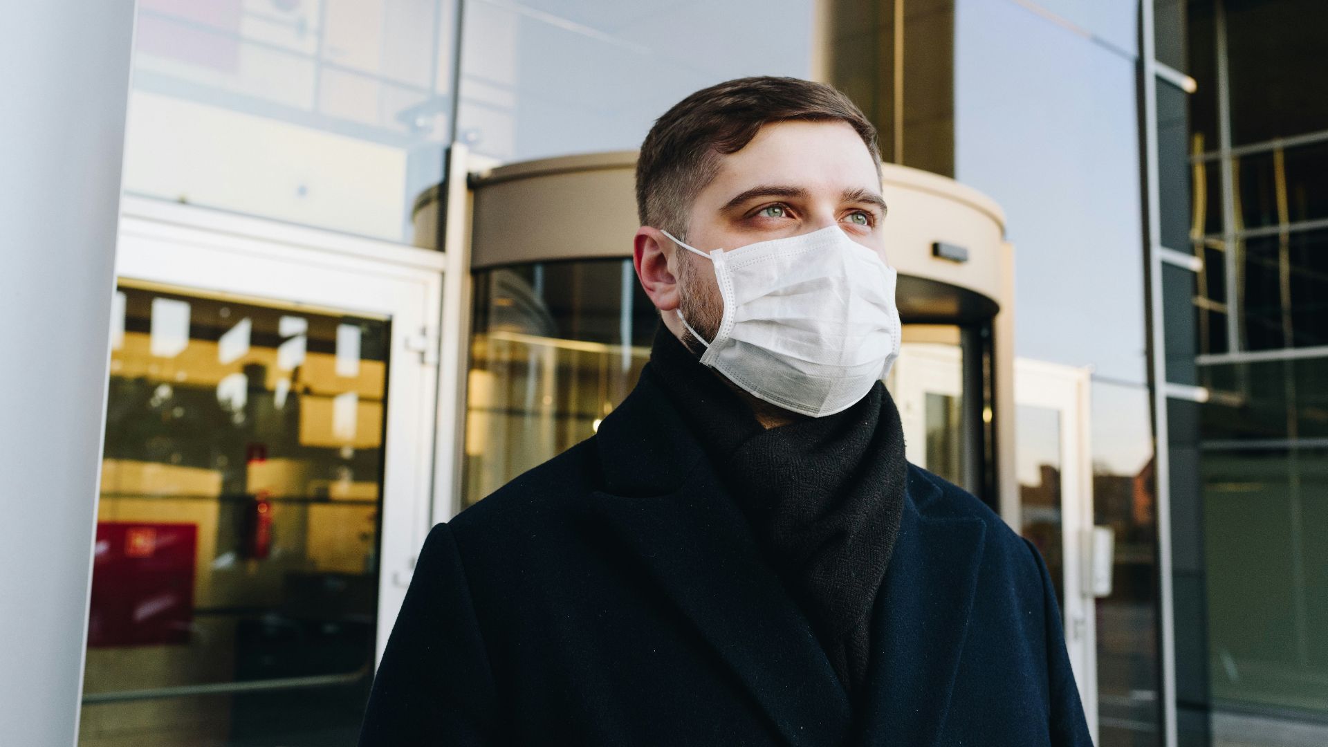 man in black robe wearing white face mask