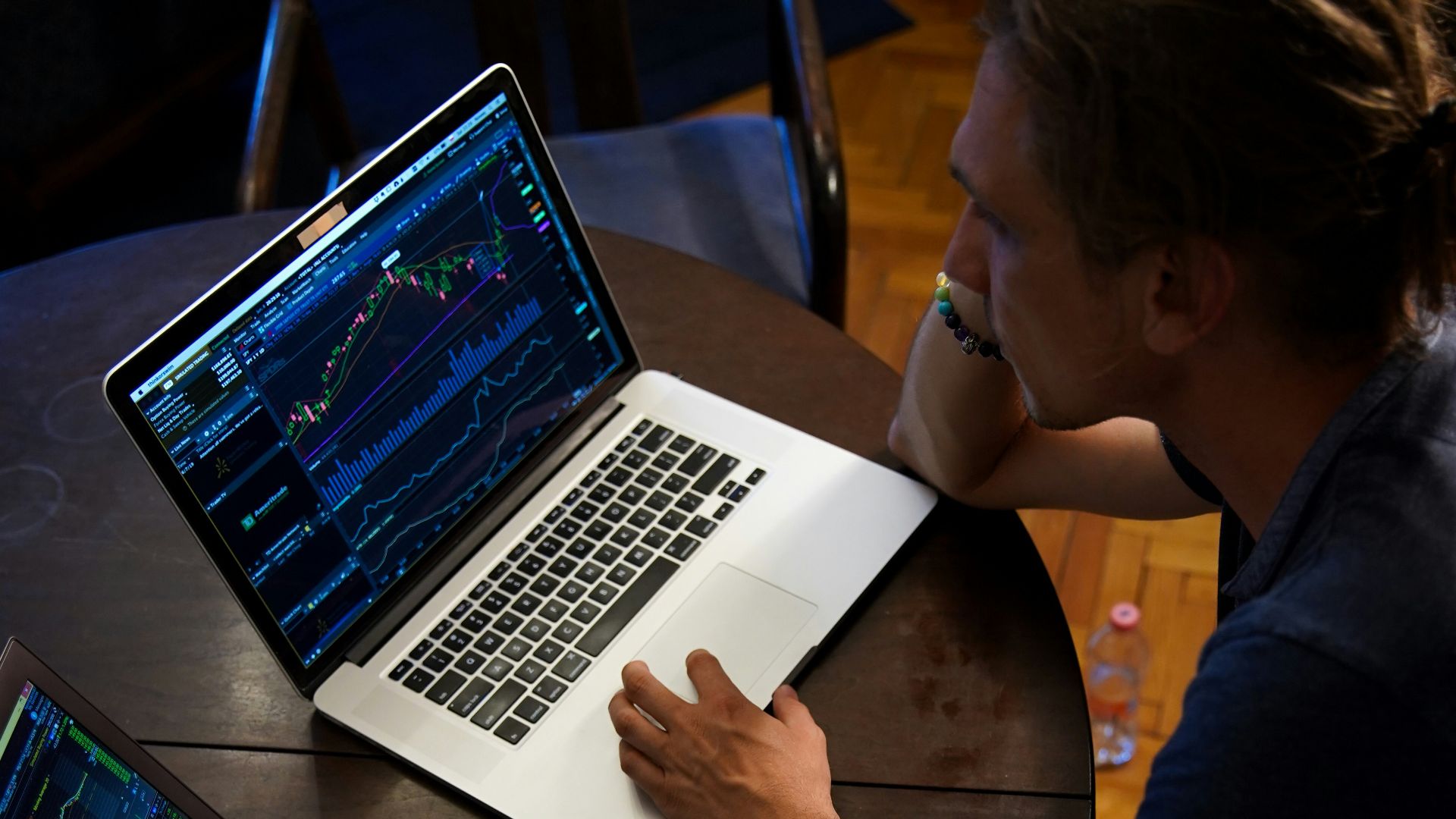 man sitting in front of the MacBook Pro