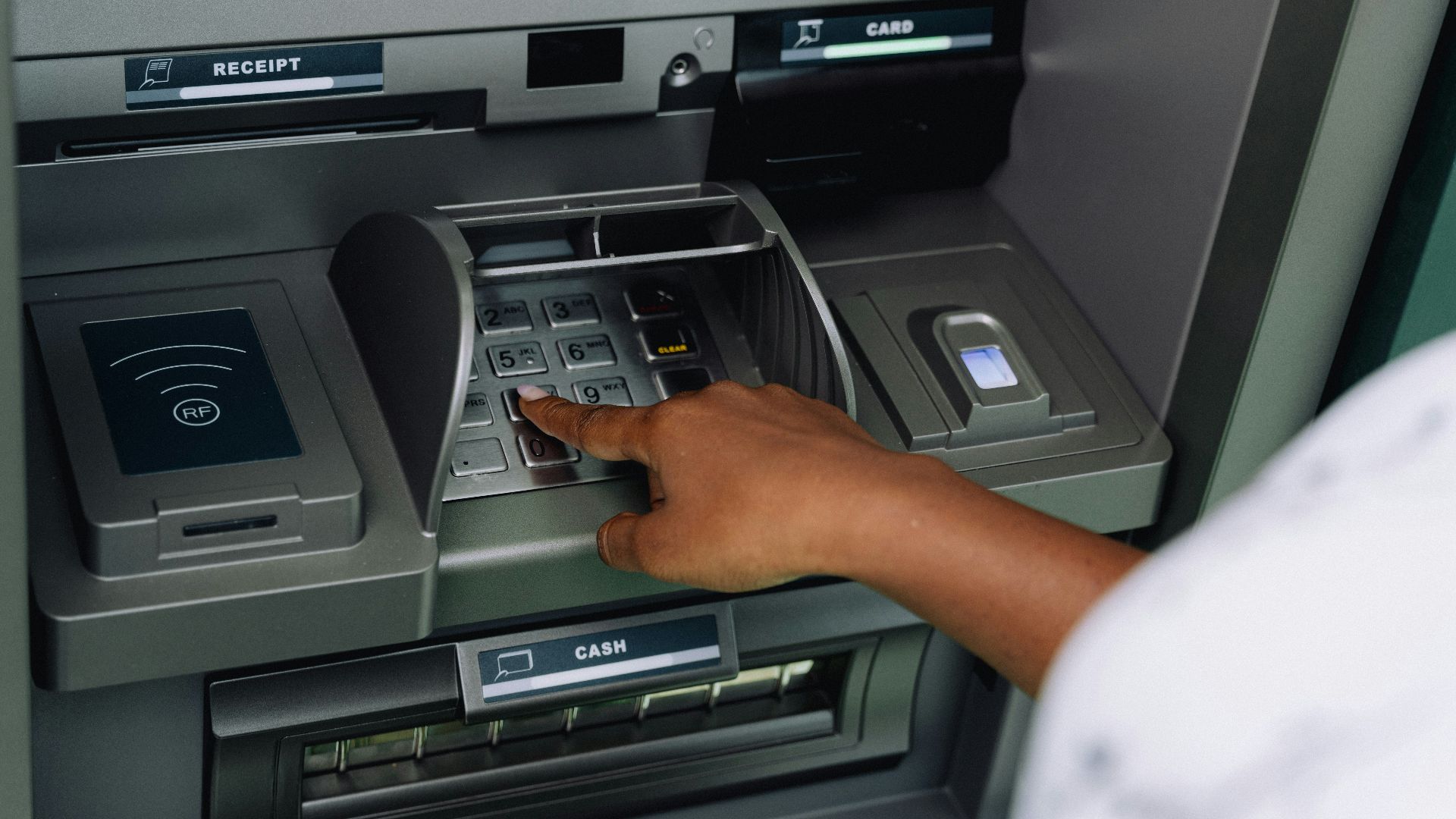 a person using an atm machine to pay money