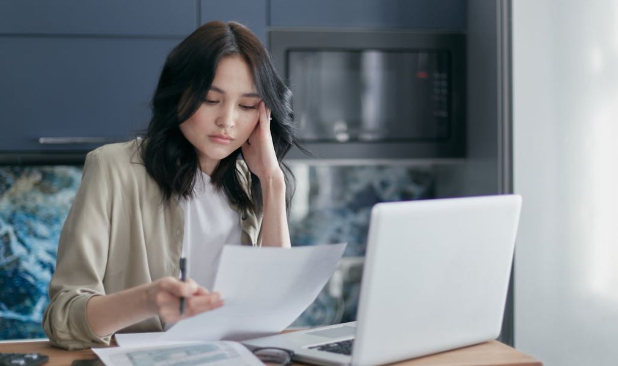 A Woman Holding a Pen and Paper