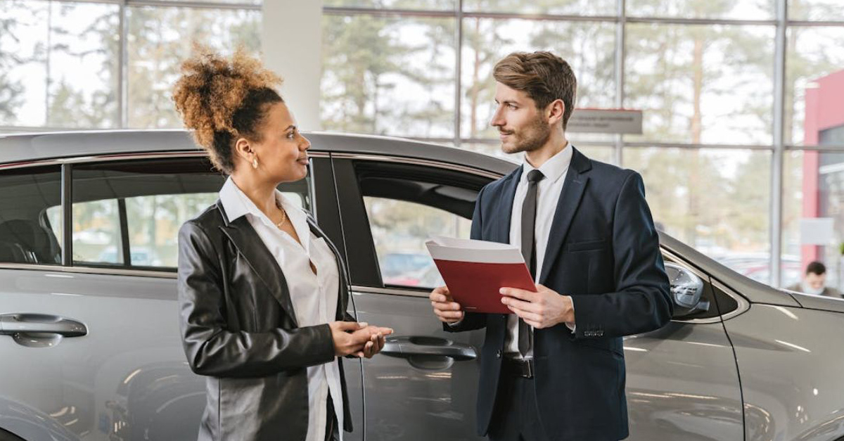 Car dealership sales man and woman