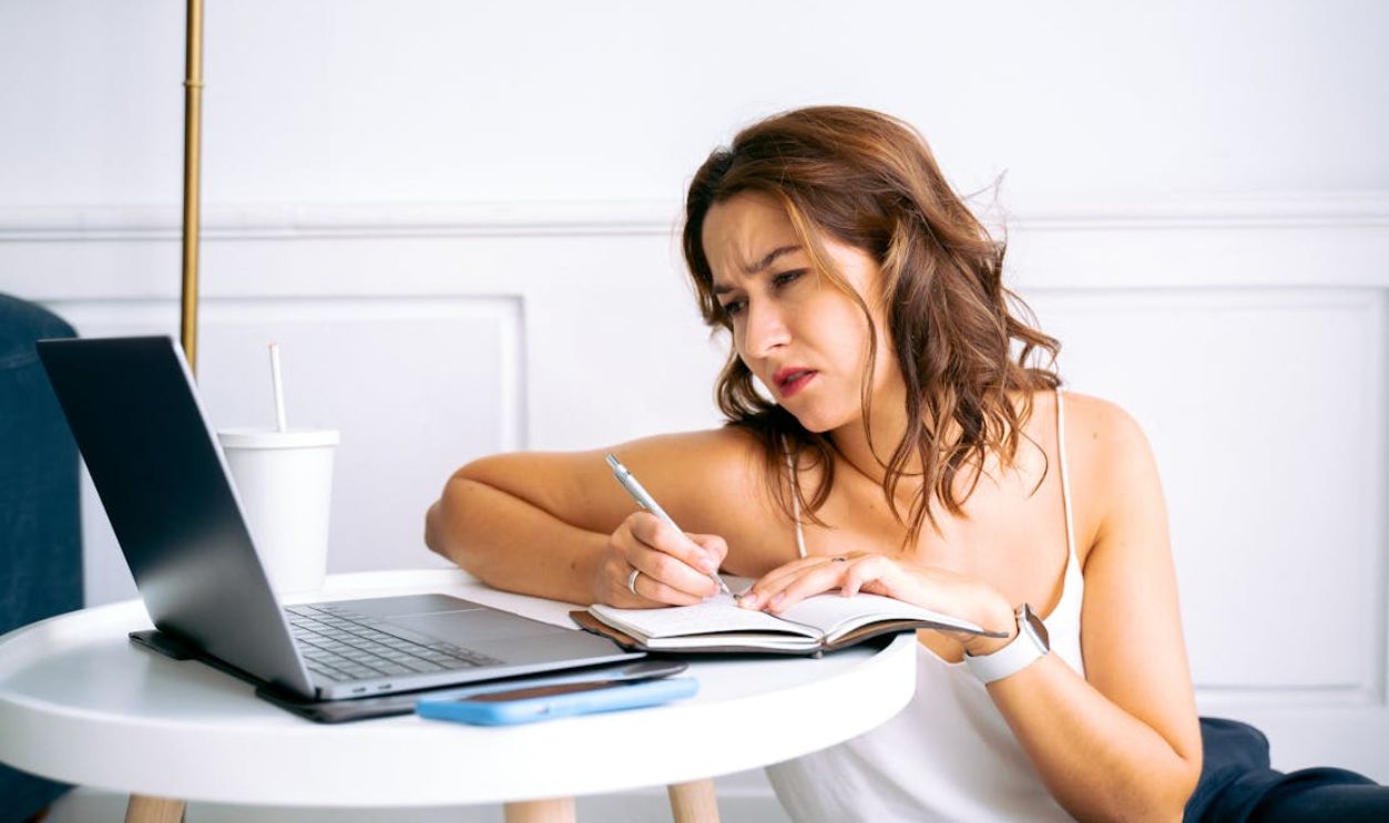 Woman in White Top Taking Notes