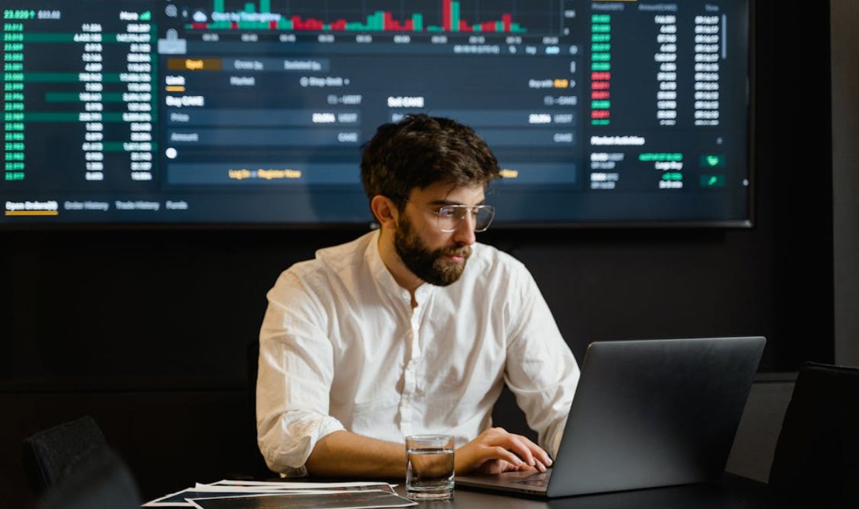 Man in White Dress Shirt Using Laptop