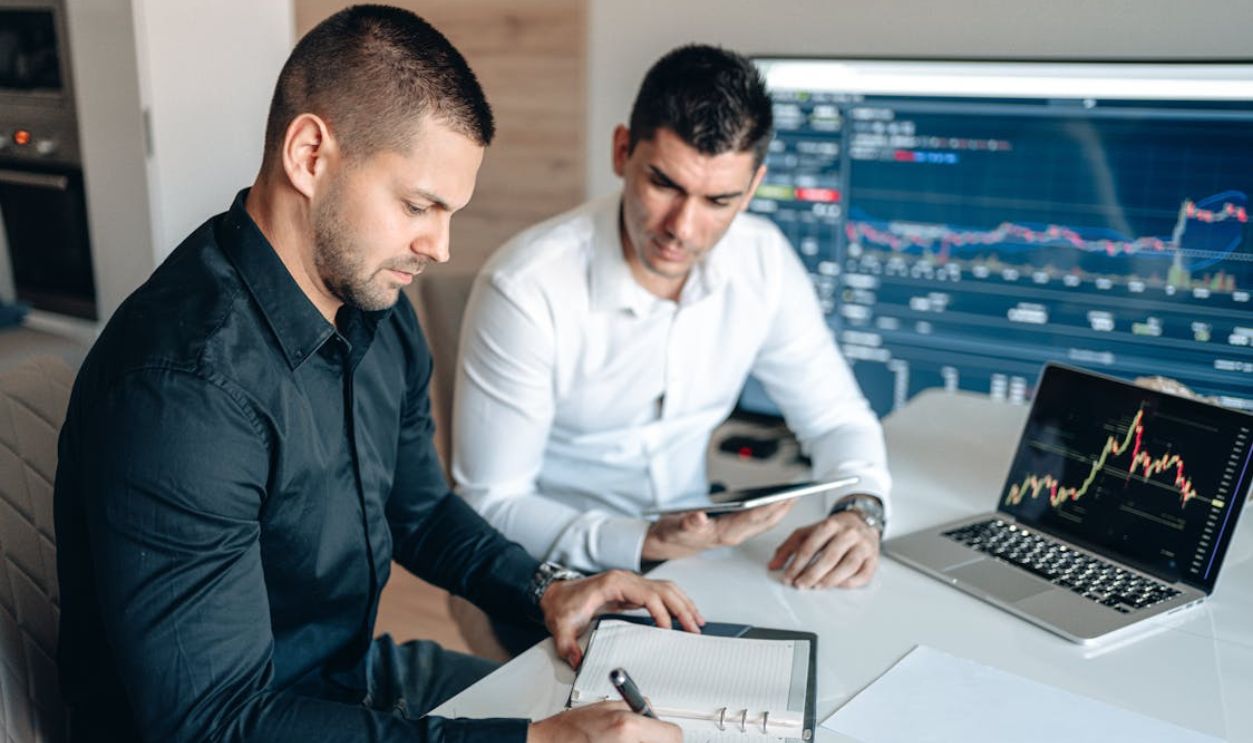 A Two Men Looking the Notebook