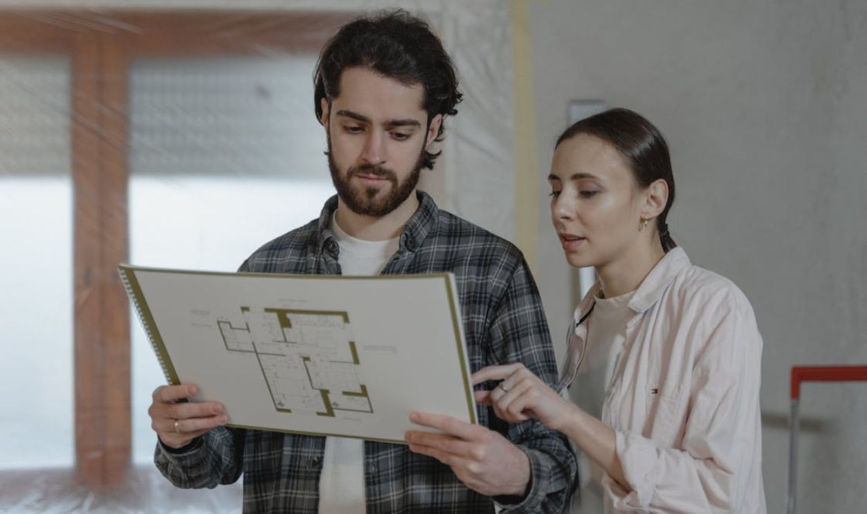 A Couple Discussing About Floor Plans