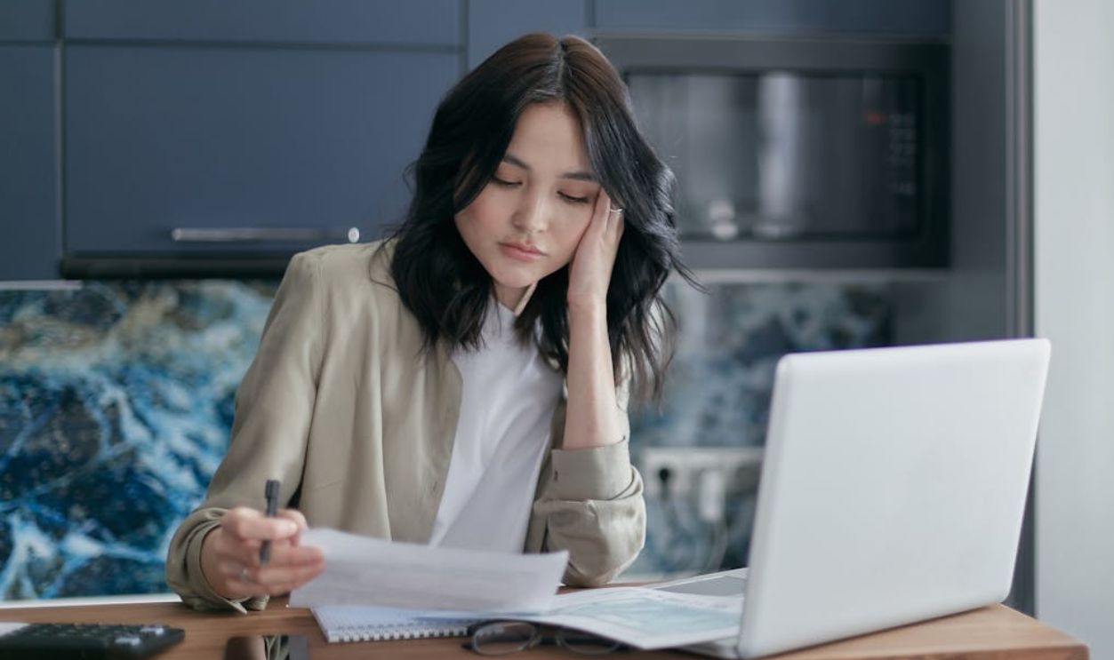 A Woman Holding a Pen and Paper