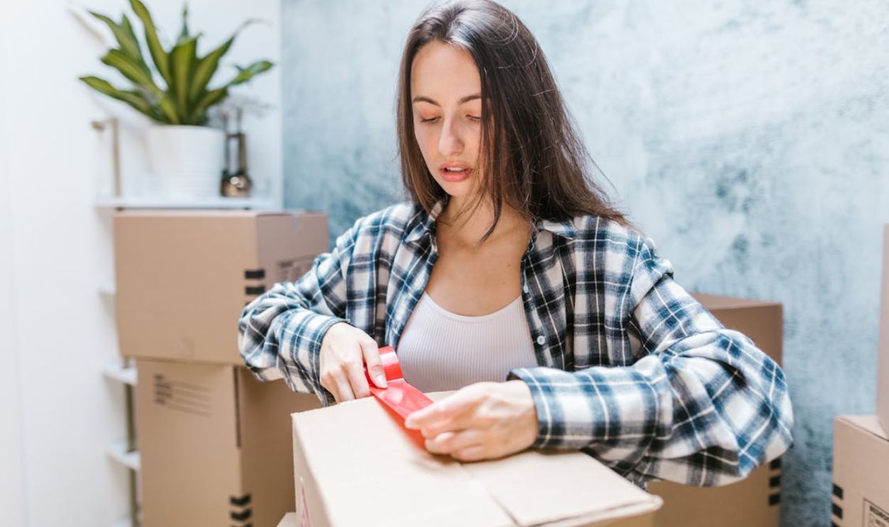 Woman Packing Moving Boxes