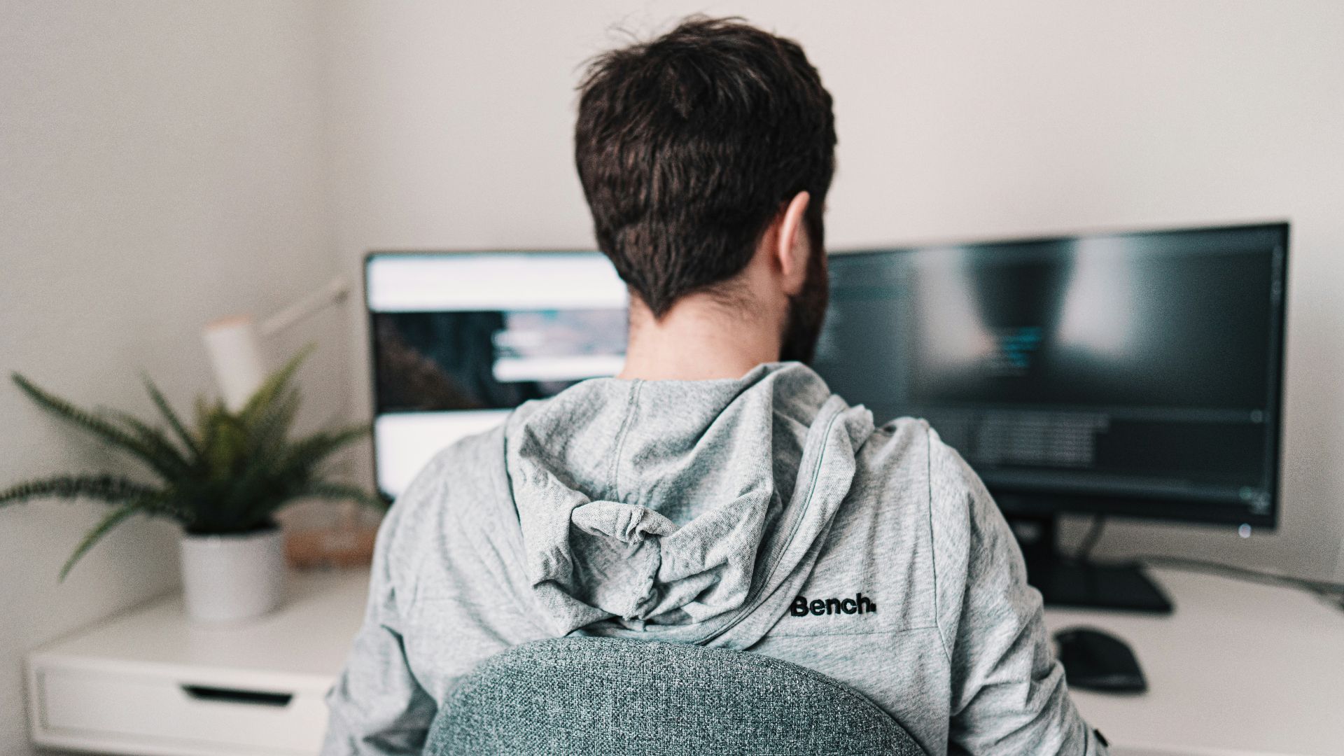 man in gray hoodie sitting on chair