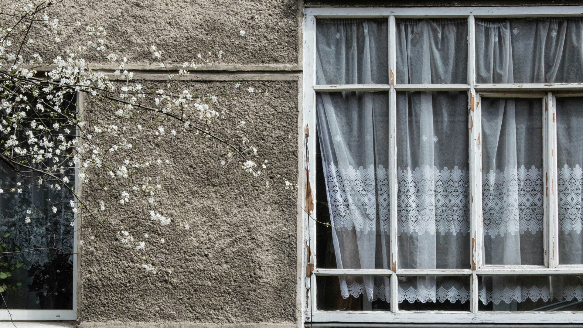 an old building with a window and a curtain