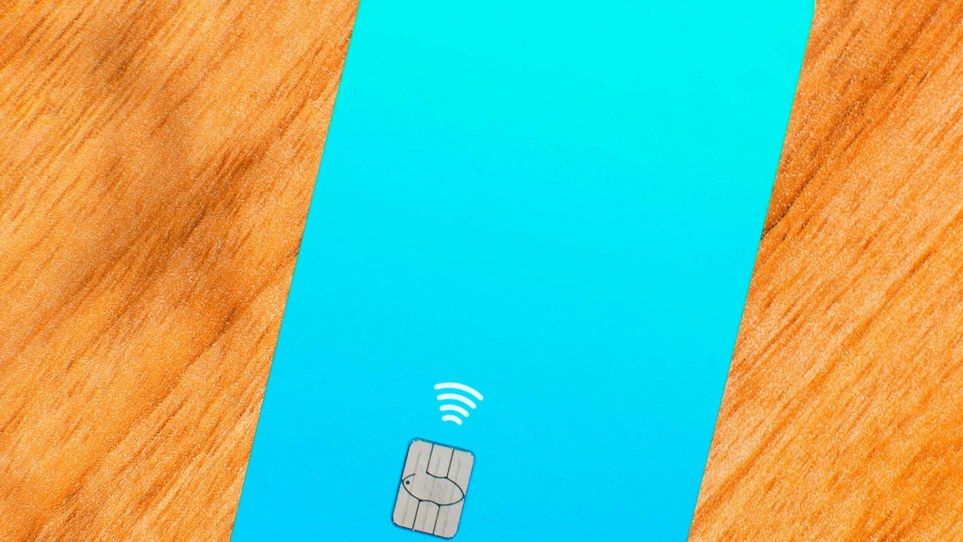 a blue sim card sitting on top of a wooden table